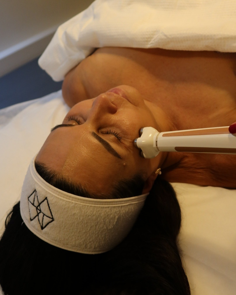 close up of a woman with FaceStim machine on face